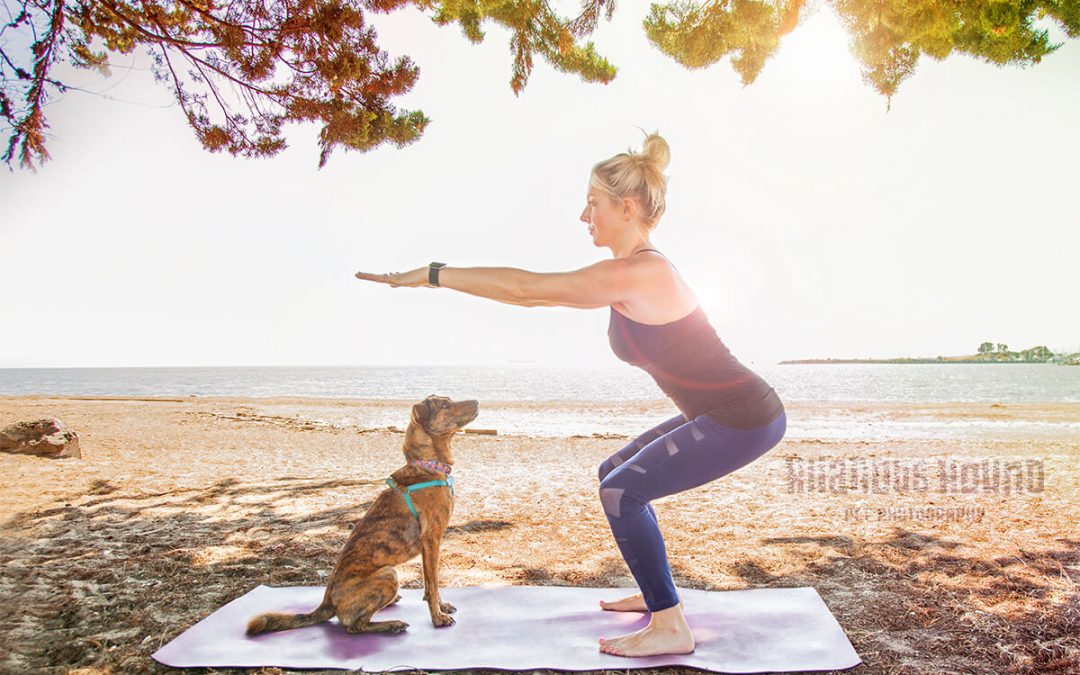 fitness with your pup women holding a squat with dog waiting patiently