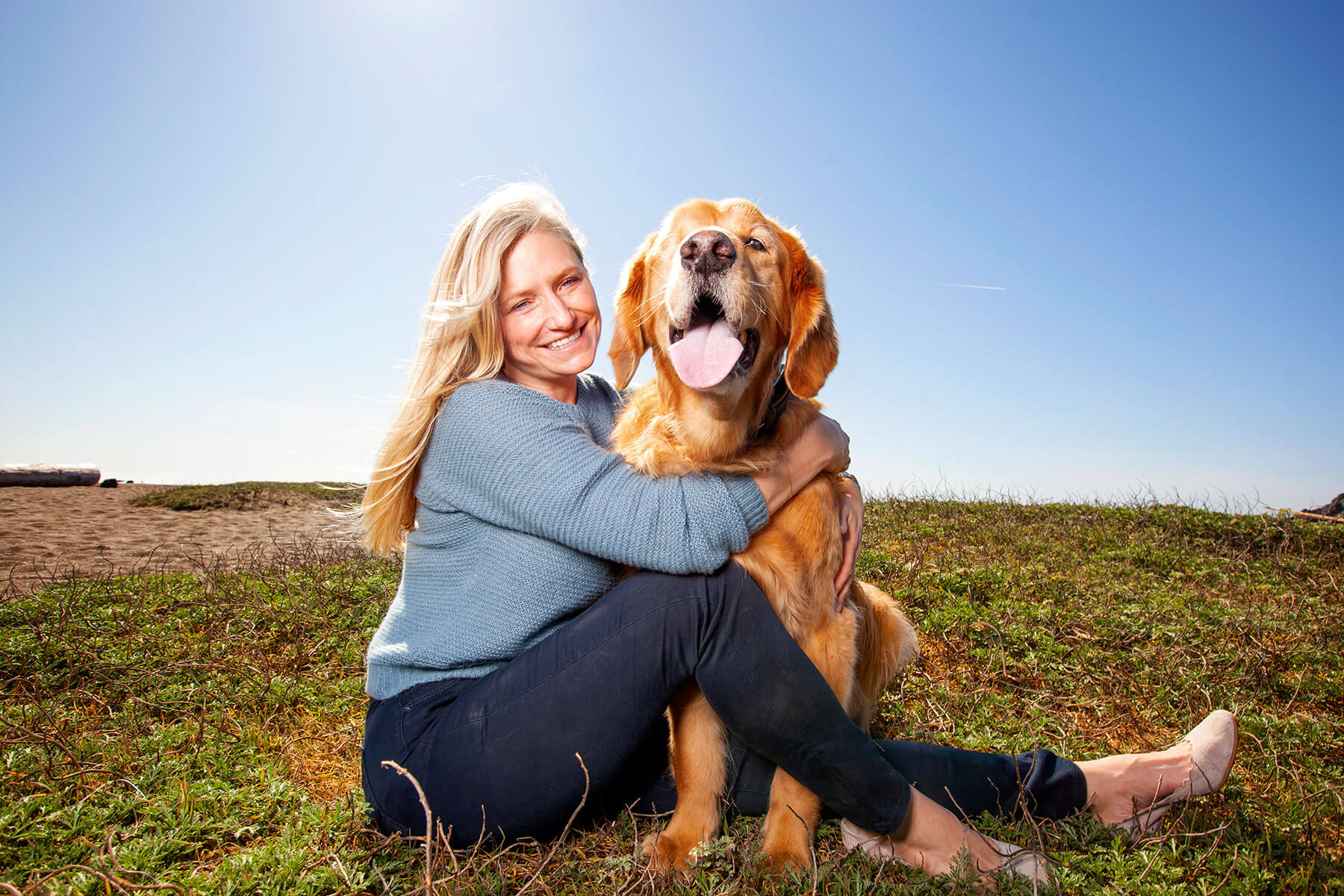 Women and her dog posing for her business brand photos featuring her dog. 