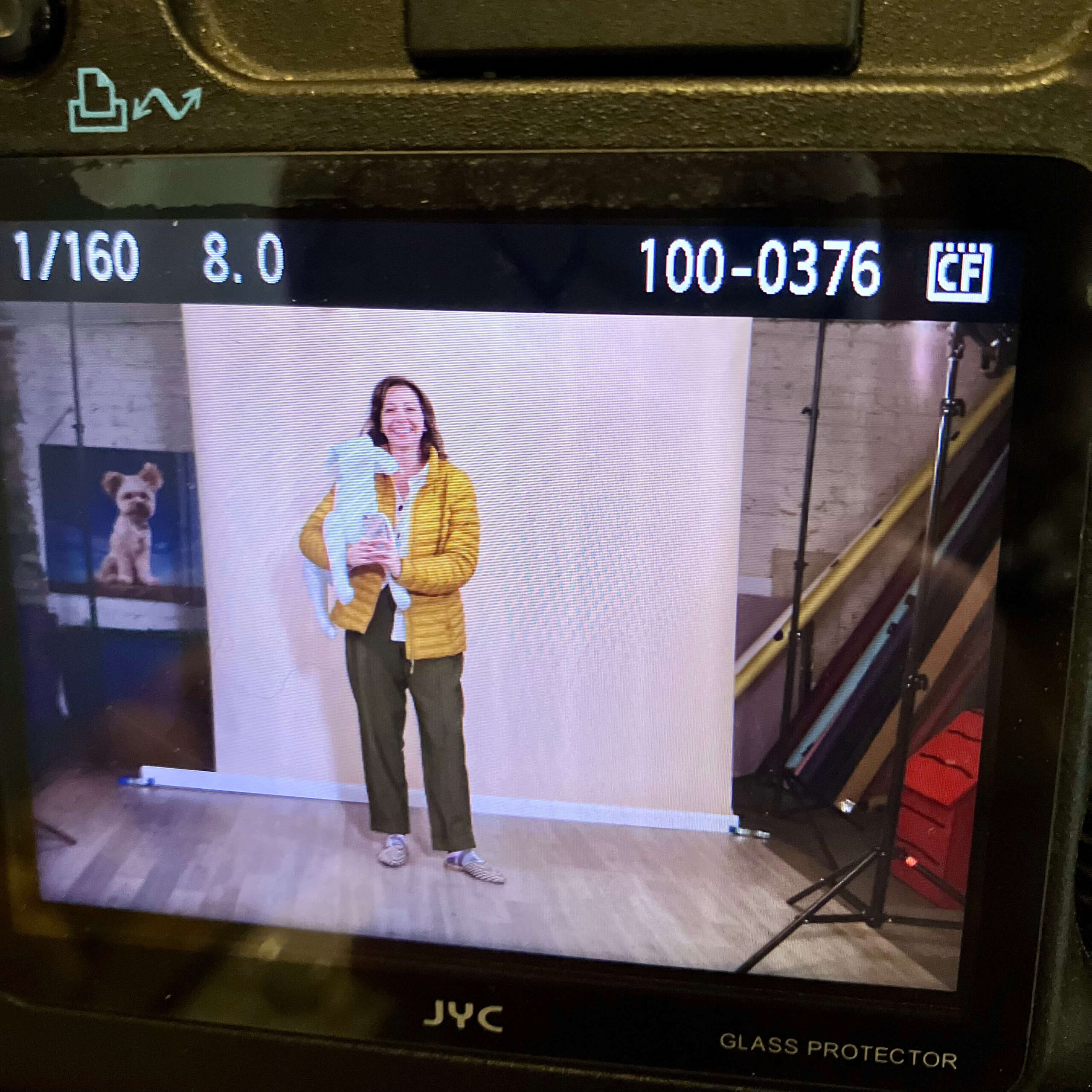 Chicago commercial photographer captured BTS holding an inflatable dog.